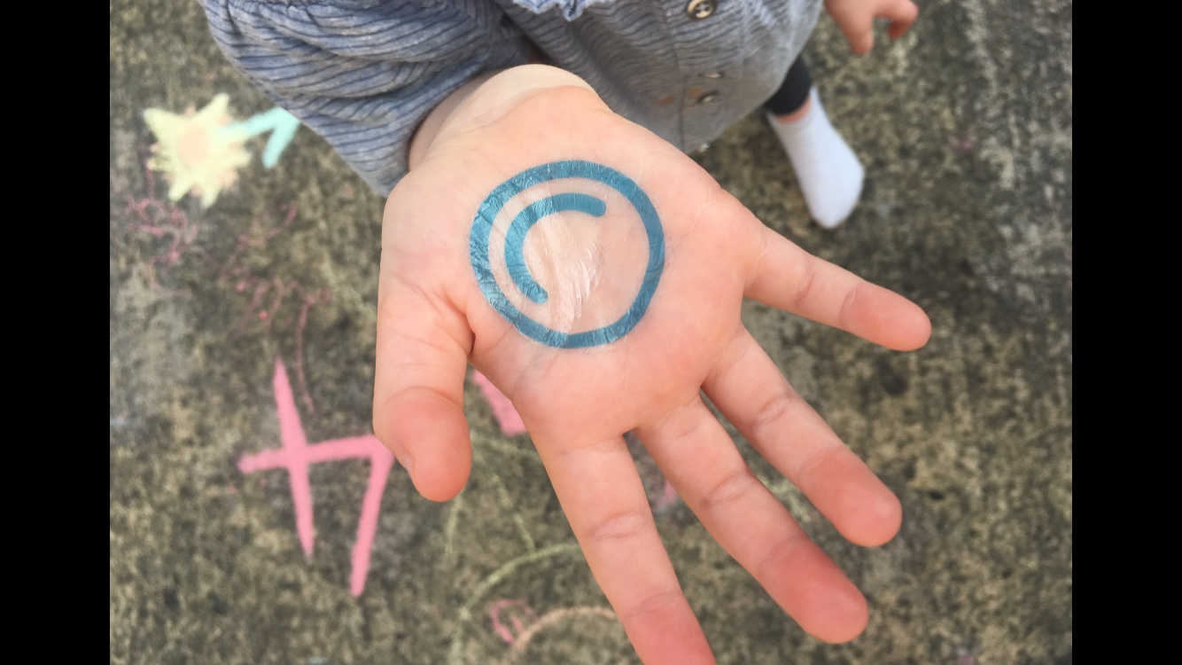 Photo of a hand with the mindmate logo on it