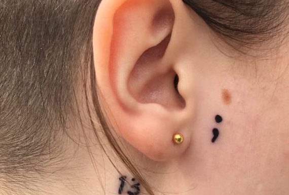 Tattoo of a semi-colon to support suicide awareness