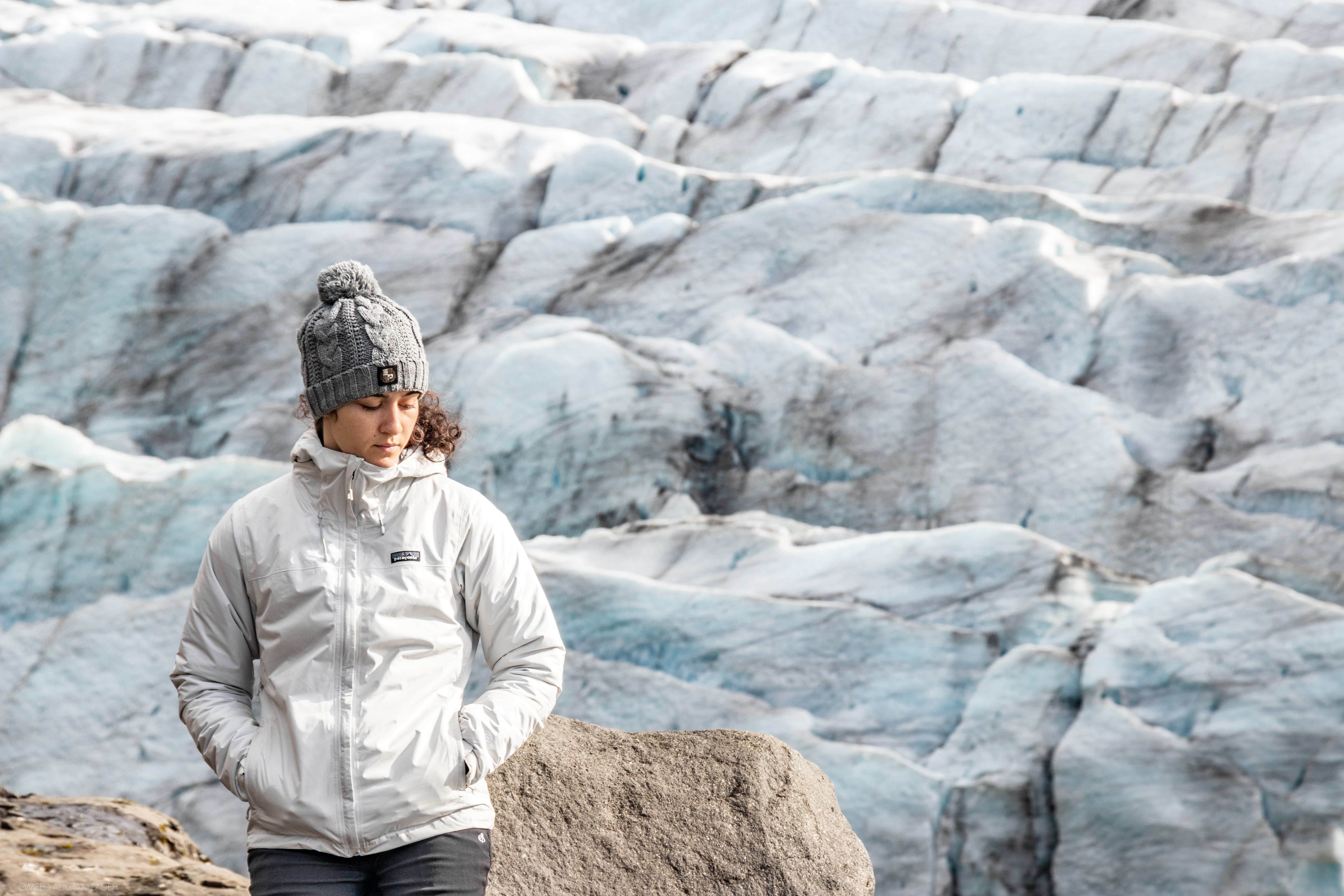 Young person on top of mountain looking down