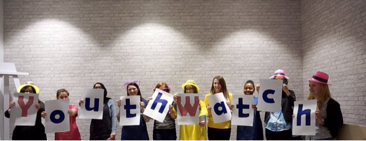 Young women holding a sign saying YOUTH WATCH