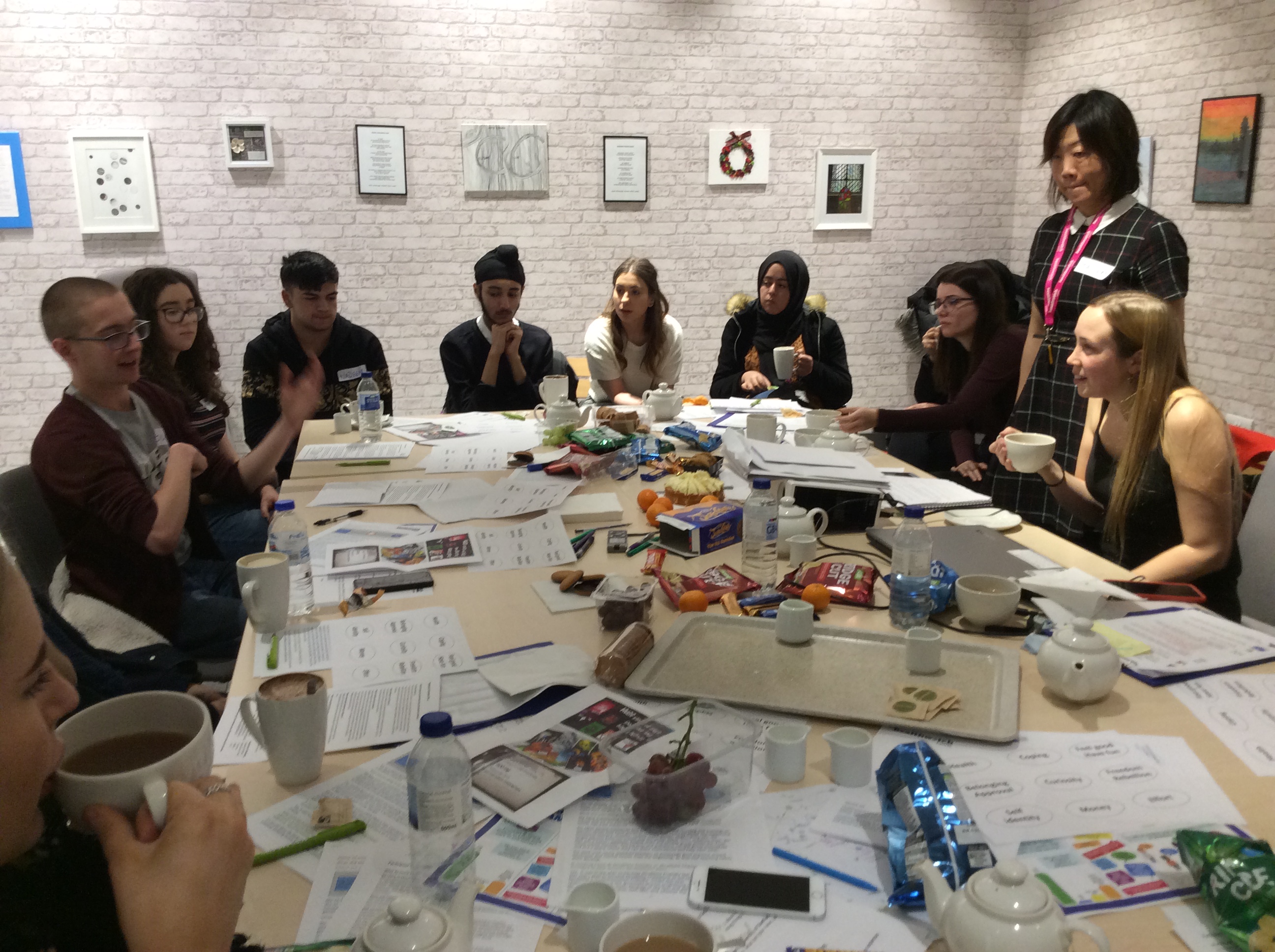 Group pf young people discussing around a table